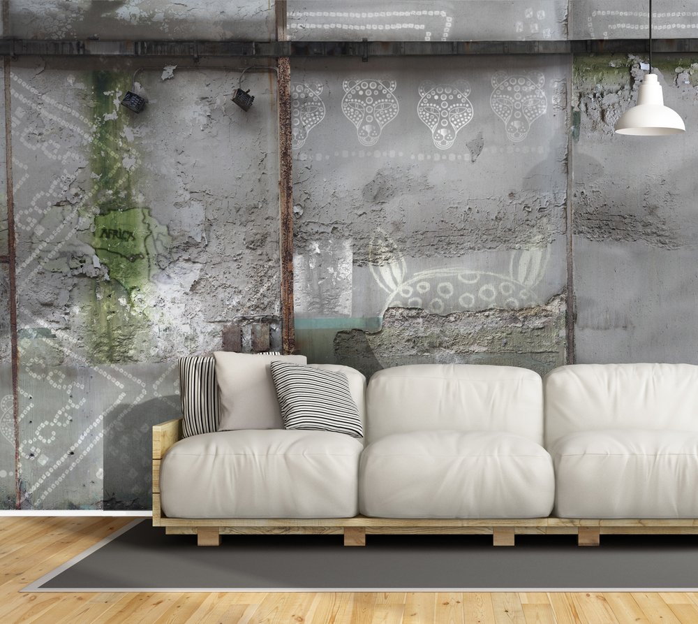 living room wall featuring a wallpaper with ethnic patterns embedded in a cement wall