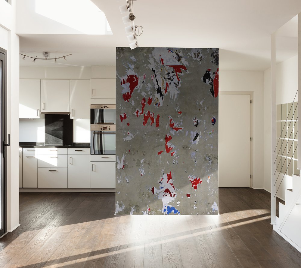 sur le mur de cette cuisine un papier peint d'affiche arrachée