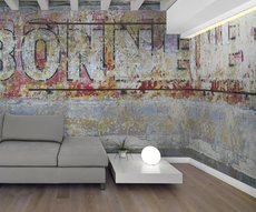 on the wall of this living room is a wallpaper representing an old advertisement of aperitif painted on the wall