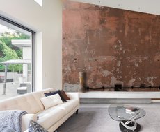 ethnic panoramic wallpaper representing a raw clay color wall in a living room