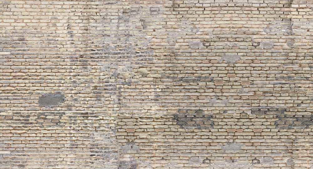 papier peint panoramique représentant un mur de brique beige