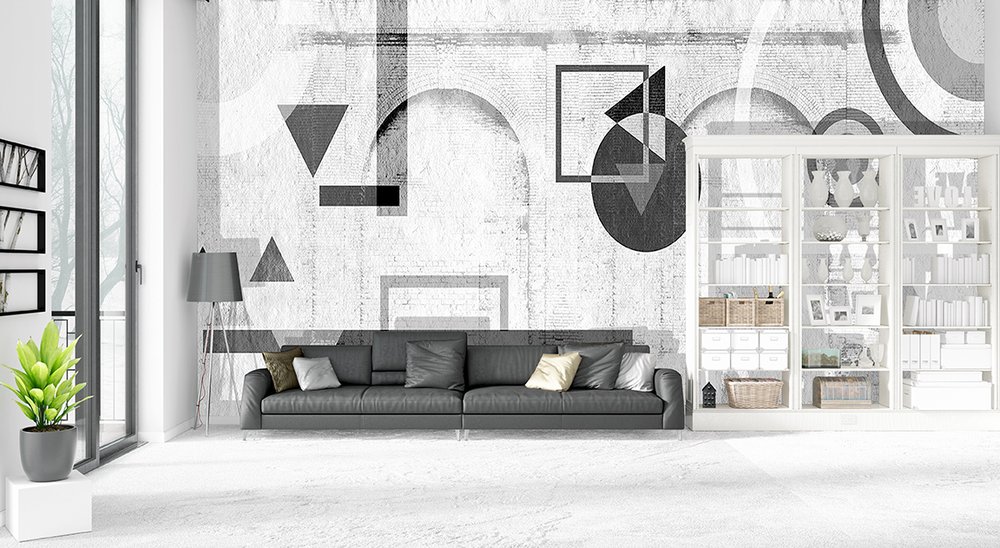 Dans un loft: papier peint panoramique tendance composé de motifs géométrie noir peints sur des briques